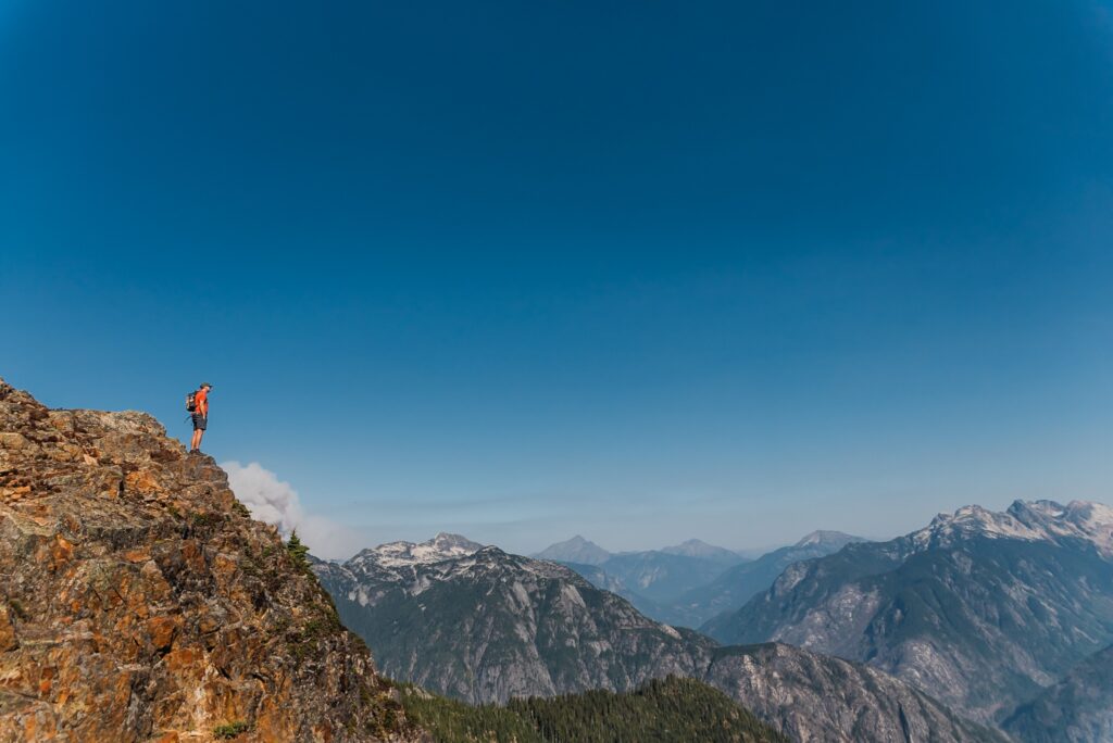 A man standing at Trappers Peak at North Cascades National Park- a stunning location for your Washington elopement