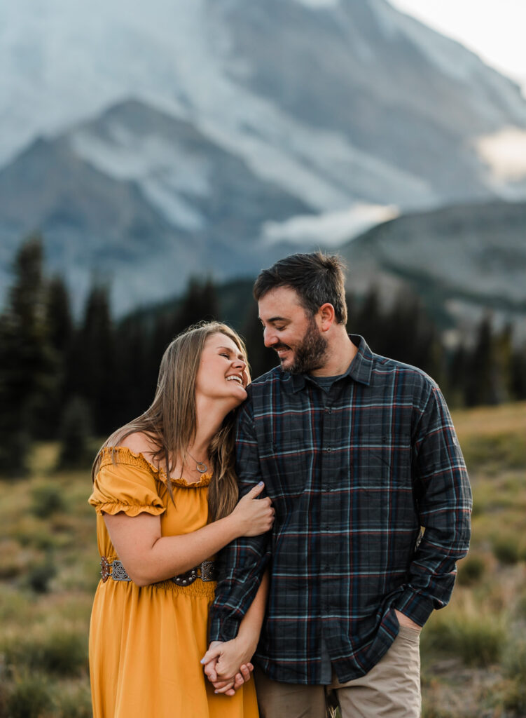 A man and woman embrace at their couples adventure session at Mount Rainier National Park 