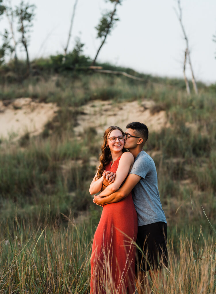 A embraces at their couples adventure session at Indiana dunes national Park