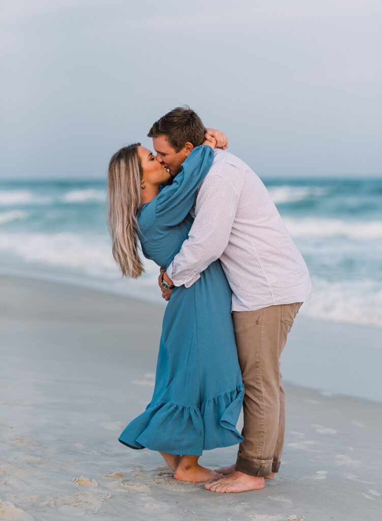 A couple kisses at their beach adventure session in Fort Morgan Alabama