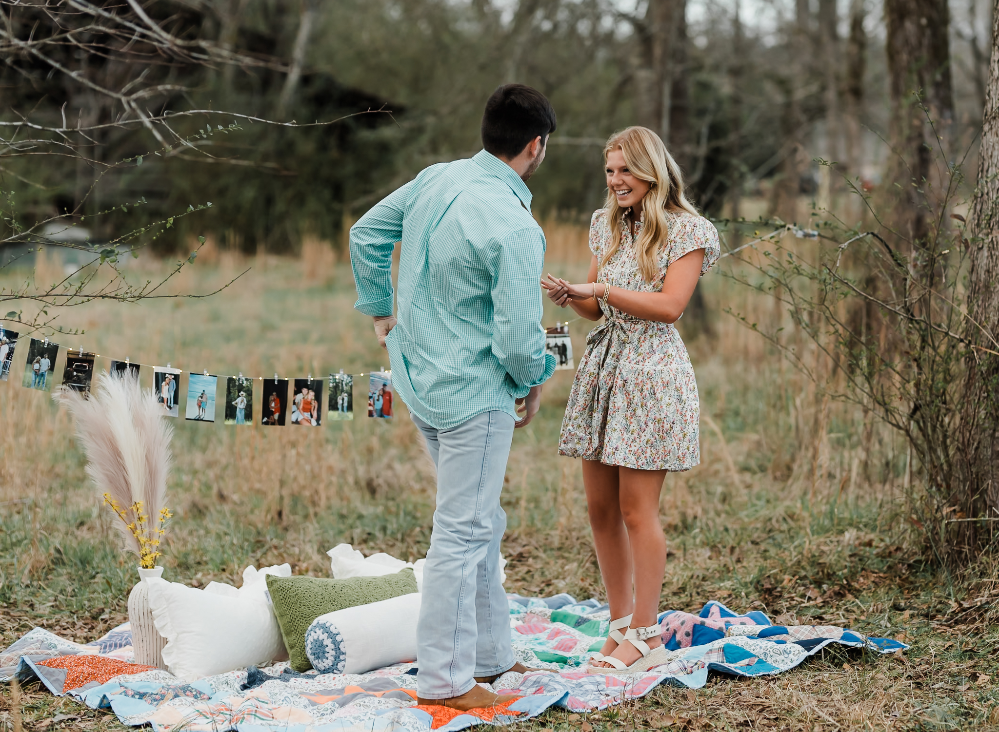 A woman is looking happily at her fiance who just proposed to her and she is holding her ring hand out