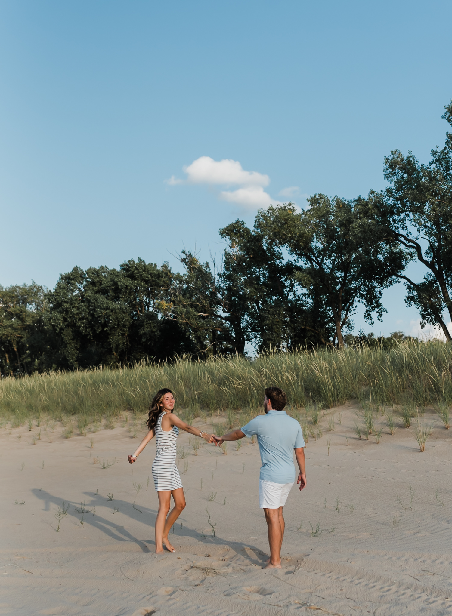 A couple dancing during their adventure session at Indiana Dunes National Park on Lake Michigan