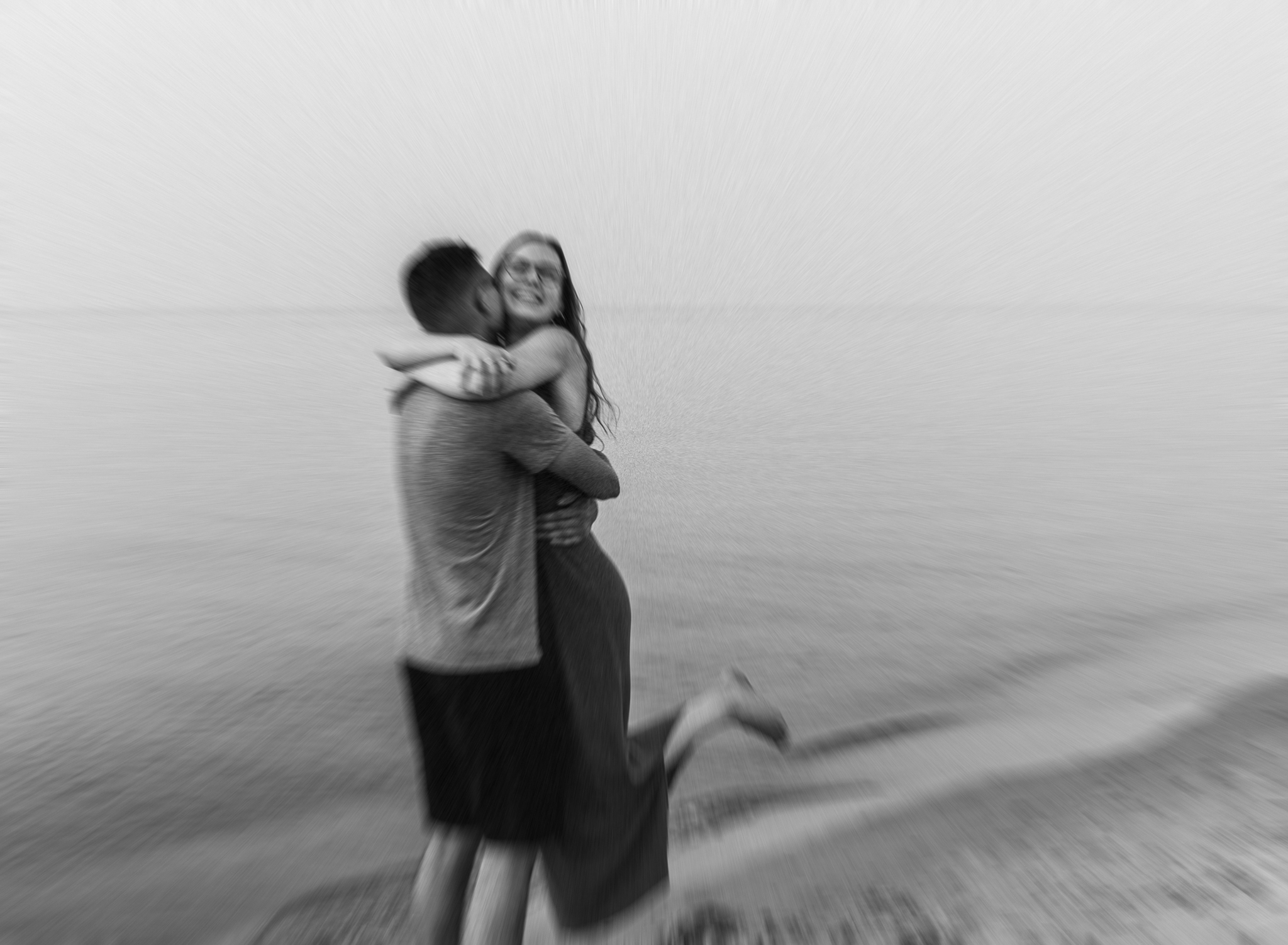 A runs into each others arms during their adventure session at Indiana Dunes National Park on Lake Michigan