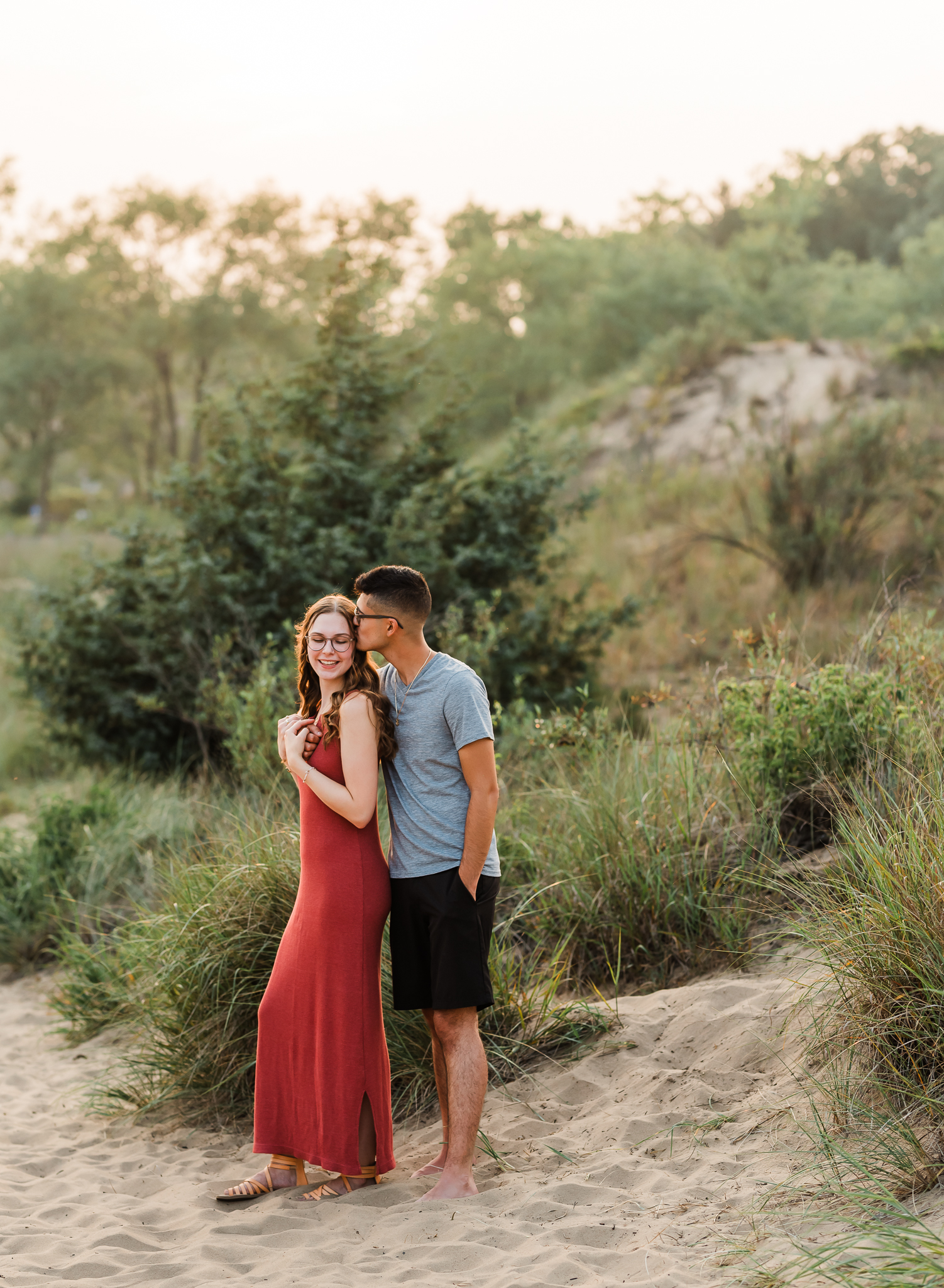 A couple embraces during their adventure session at Indiana Dunes National Park on Lake Michigan
