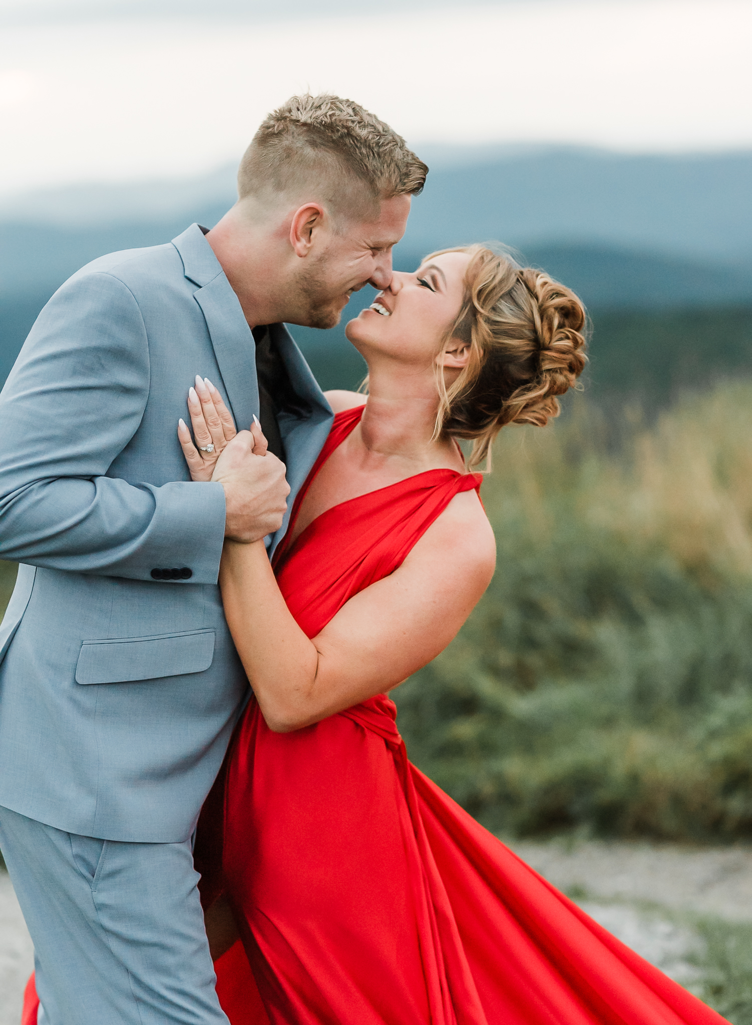 A woman and man embrace at their engagement session in Max Patch North Carolina.
