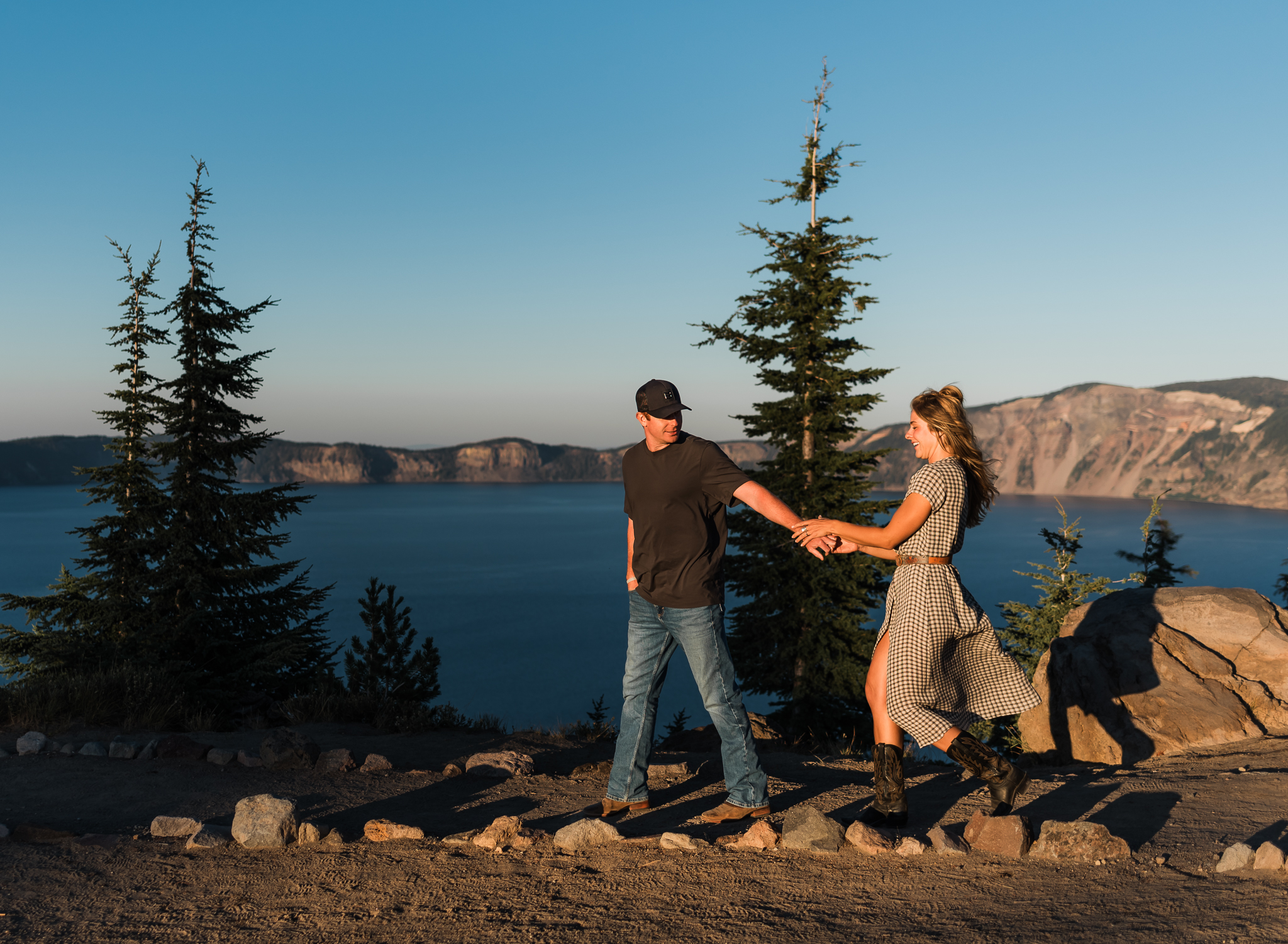 A couple walking on a trail at their Crater Lake National Park engagement session.
