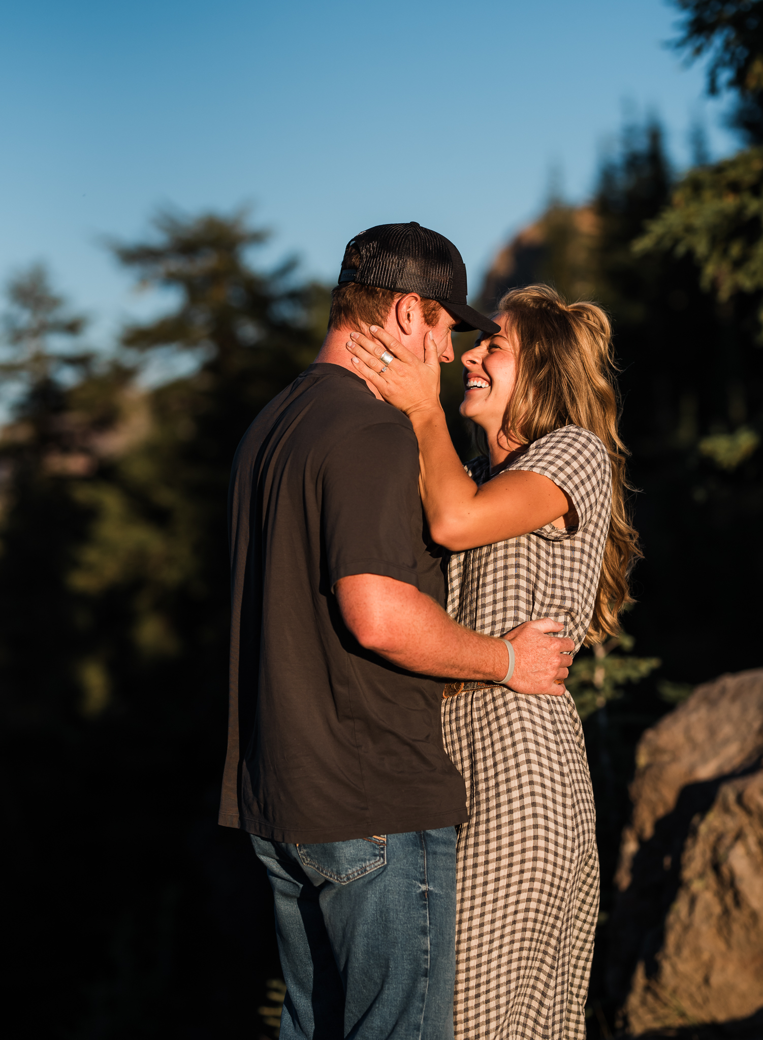 A couple embracing at an overlook at their Crater Lake National Park engagement session.