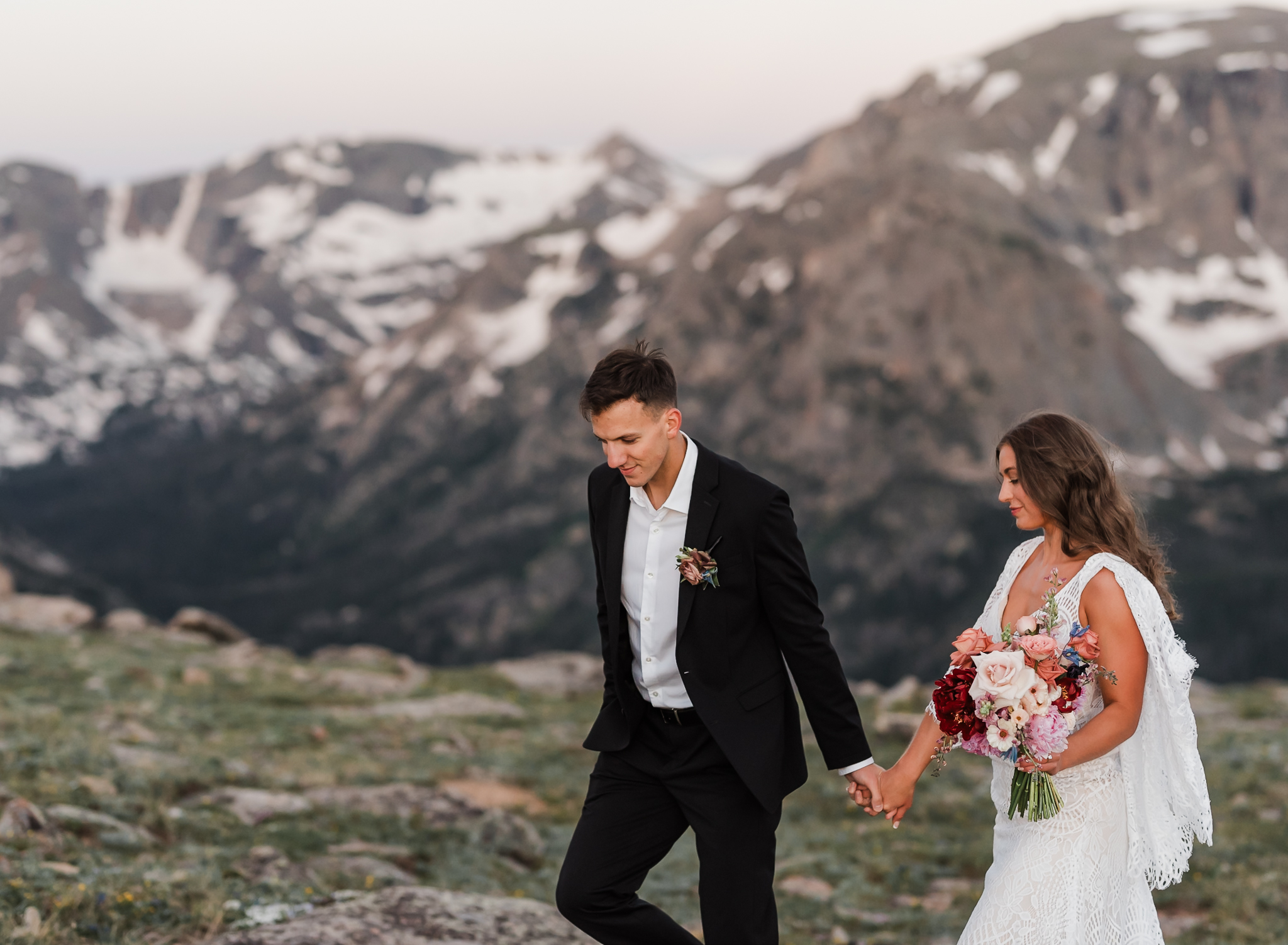 A bride and groom walk hand and hand at their Colorado elopement.