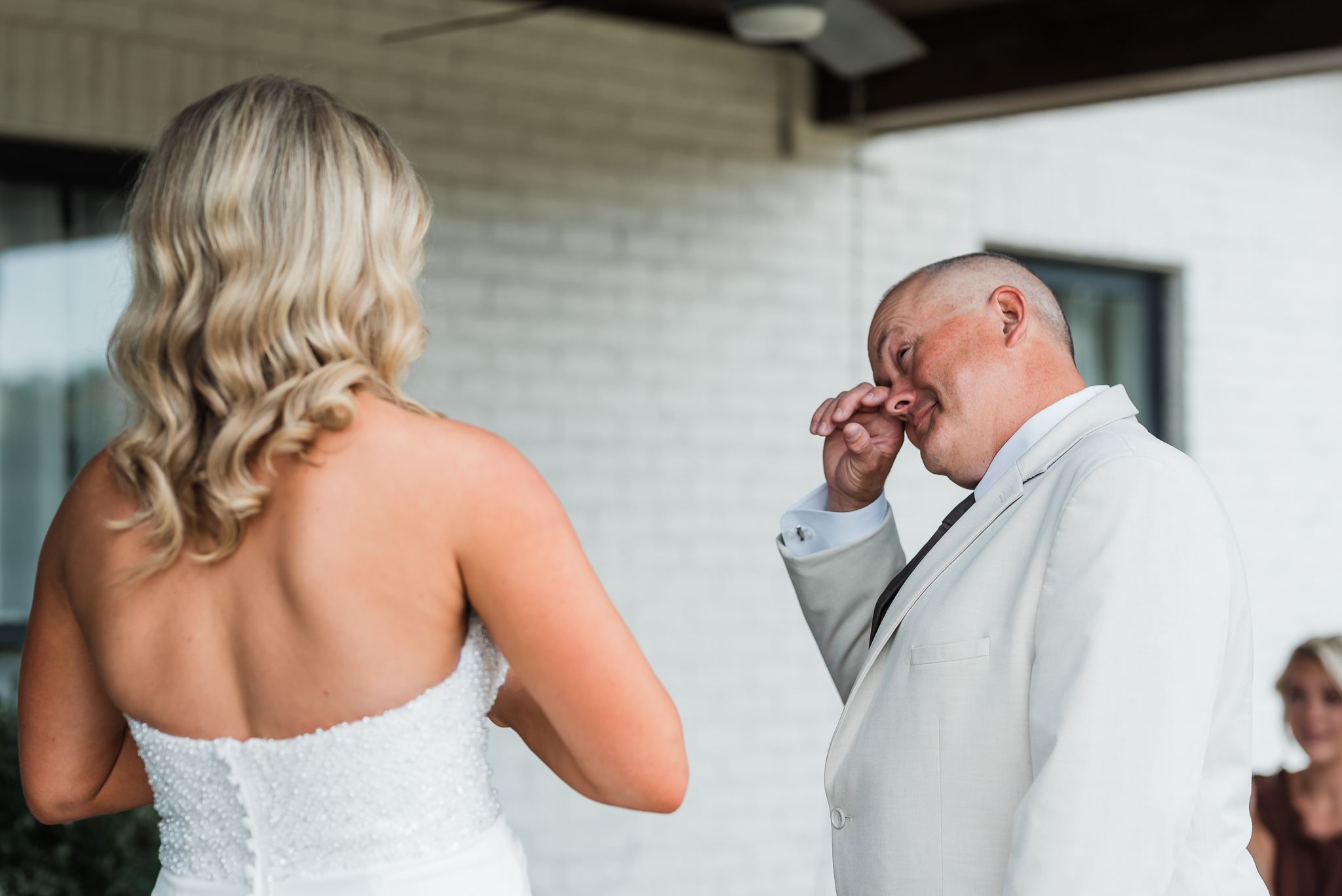 A dad cries at the first look of his daughter in her wedding dress at her intimate wedding